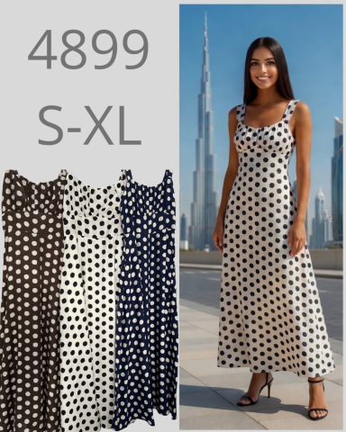 Modelo luciendo un vestido largo de lunares, con el Burj Khalifa de fondo. Varias opciones de color.
