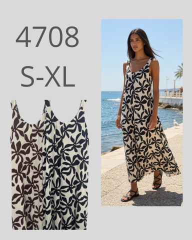 Vestido largo de flores en tonos blanco y negro, modelo en la playa. Tallas S-XL.