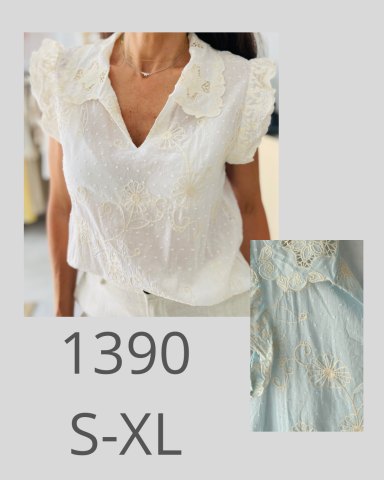 Blusa blanca con detalles de flores, disponible en tallas S a XL.