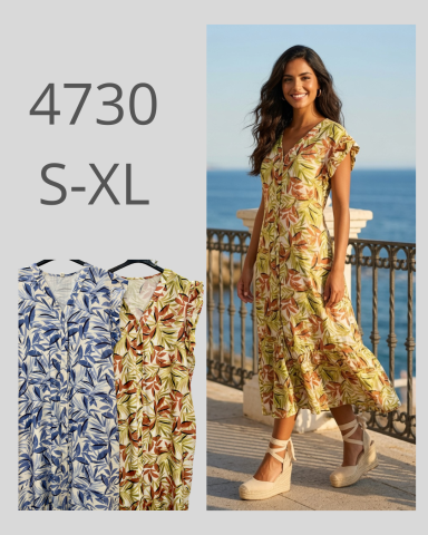 Vestido largo con estampado floral, en tonos amarillo y verde, en un entorno costero.