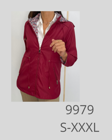 Chaqueta roja con capucha, combinada con camisa blanca y pantalones claros. Modelo femenino.