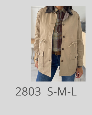 Chaqueta beige con detalles oscuros, combinada con una camisa de cuadros y jeans.
