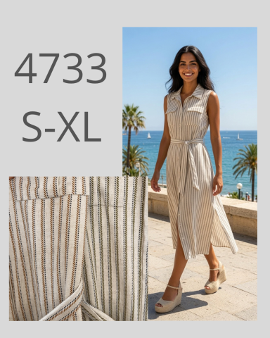 Mujer con vestido de rayas, de pie frente al mar, con sandalias y un paisaje soleado.