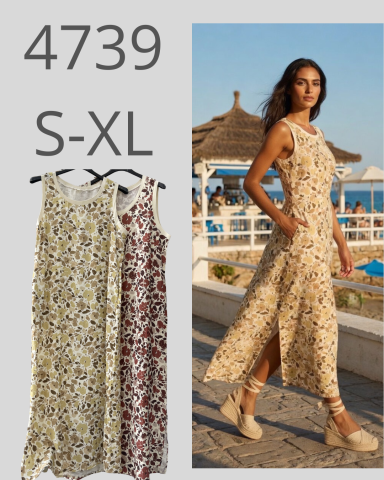 Vestido largo con estampado floral, disponible en tallas S-XL, modelo en un entorno costero.