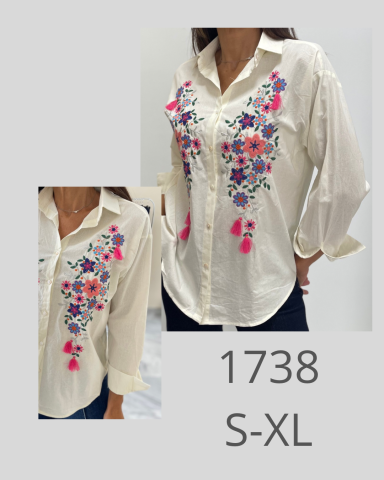 Camisa blanca con bordado floral colorido y detalles en fucsia, tallas S-XL.