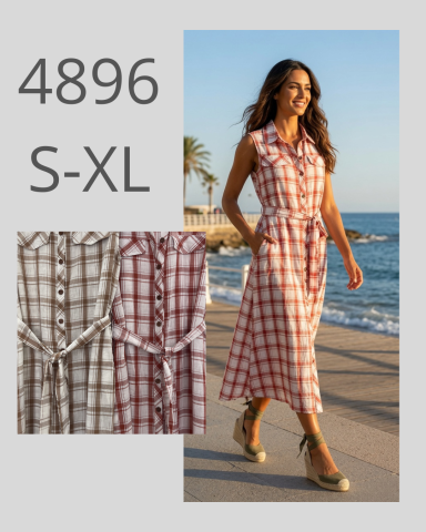 Mujer caminando en un vestido de cuadros, con fondo de playa y palmeras.
